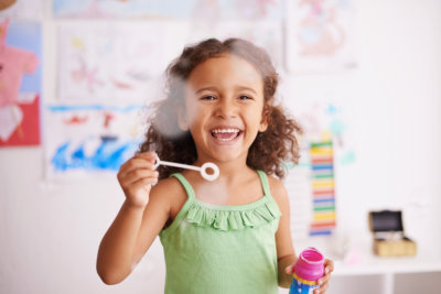 little girl playing bubbles