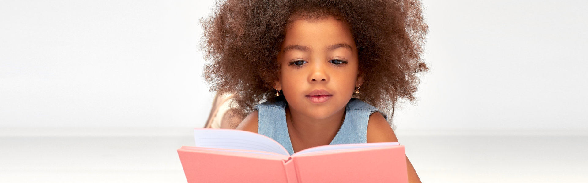 little kid reading a book